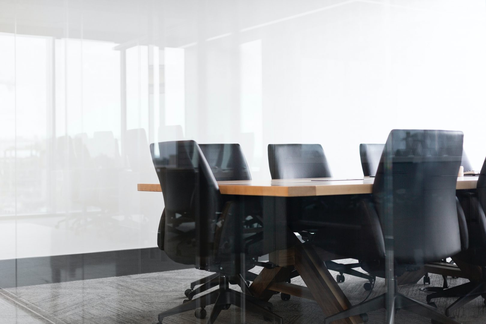 black rolling chairs beside brown table